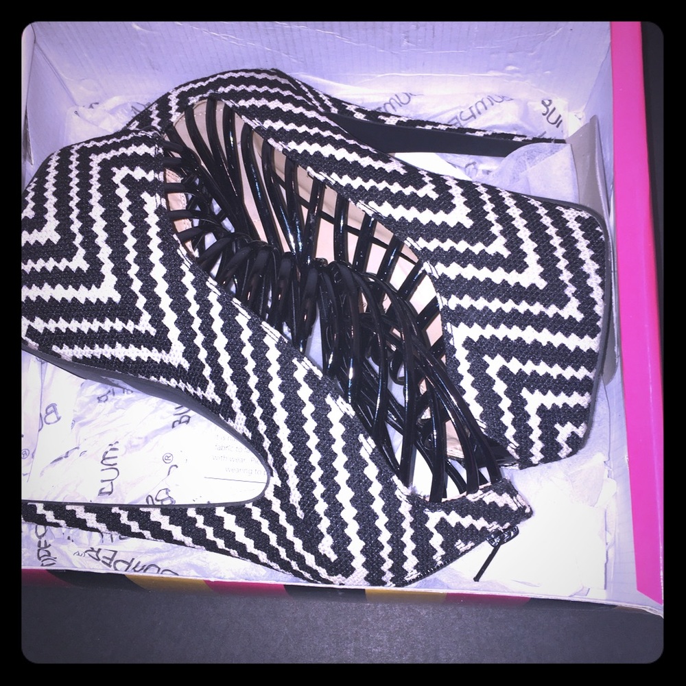 Black and white colored booties with straps